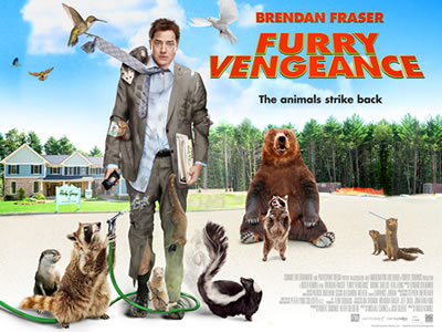 Furry Vengeance UK poster. A man stands facing the camera. His suit is torn and covered in animal paw-prints.  He is surrounded by forest animals who are attacking him.
