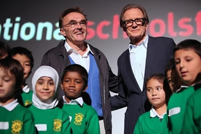2 men stand with a group of school children at the launch of national Schools Film Week 2009
