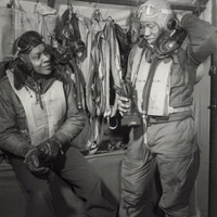 Two pilots wearing uniforms talking to each other